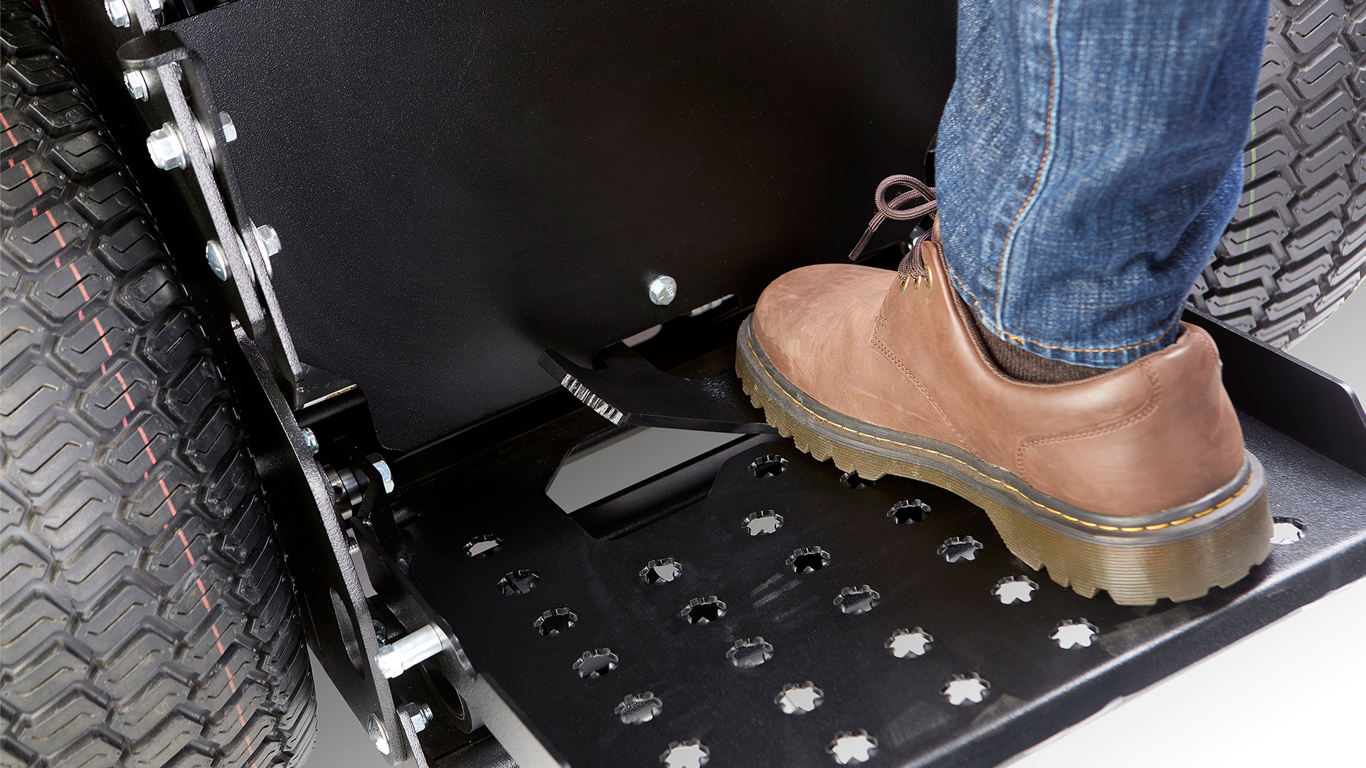 a person's feet on a car tire